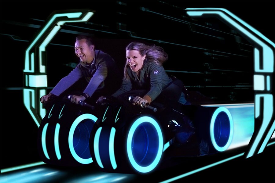 Guests smiling while riding TRON Lightcycle / Run presented by Enterprise