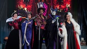Cruella de Vil poses with other Disney villains